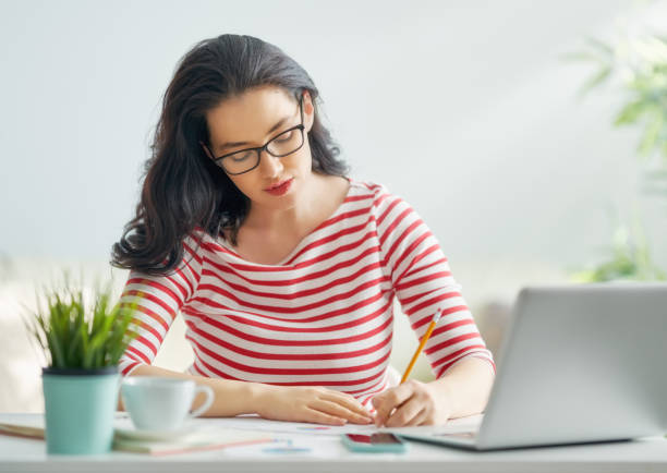 istock woman working on a laptop 1129283101