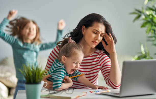 mother with children working on computer stock photo