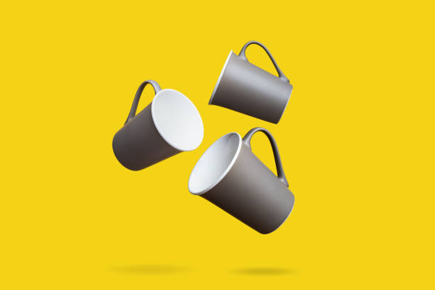 istock Flying Concept of Red Coffee Tea Cup on Yellow Background 1129285857