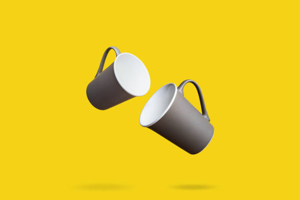 istock Flying Concept of Red Coffee Tea Cup on Yellow Background 1129285879
