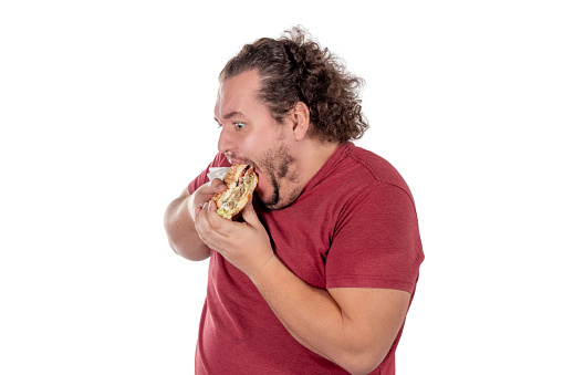 Funny fat man eating hamburger. Fast food, unhealty eat