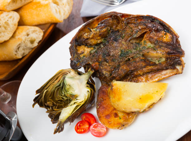 istock Cabeza de cordero - spanish dish. Lamb head with artichoke, tomatoes and potatoes 1129291267