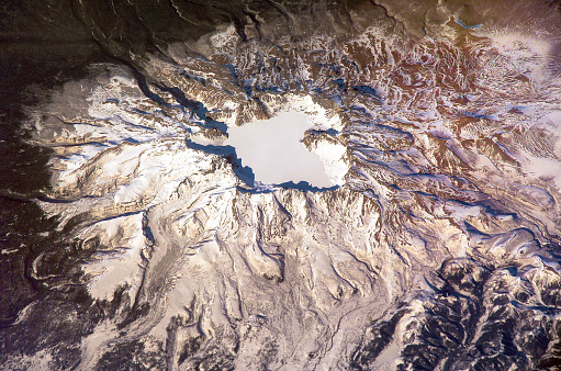 Aerial view of Lonquimay volcano behind a mountain in La Araucania region, southern Chile