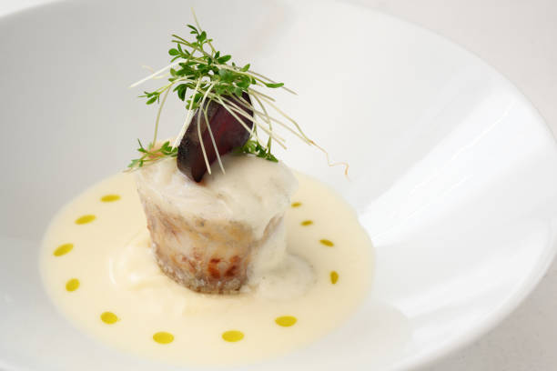 istock pike roll with beetroot and cress garnish in a creamy sauce in a deep white bowl, copy space 1129293046