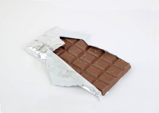 istock Partially Unwrapped Bar of Chocolate 1129294861