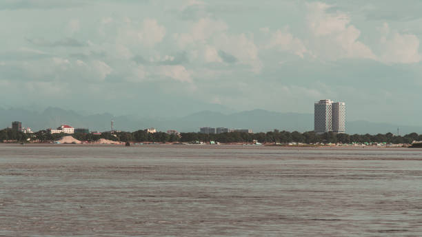 istock Building on the river and mountains in background 1129296042