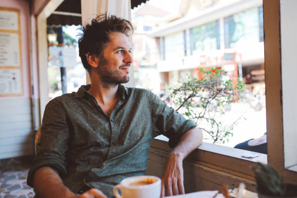 istock Young man having a coffee in Bali, Indonesia 1129296061