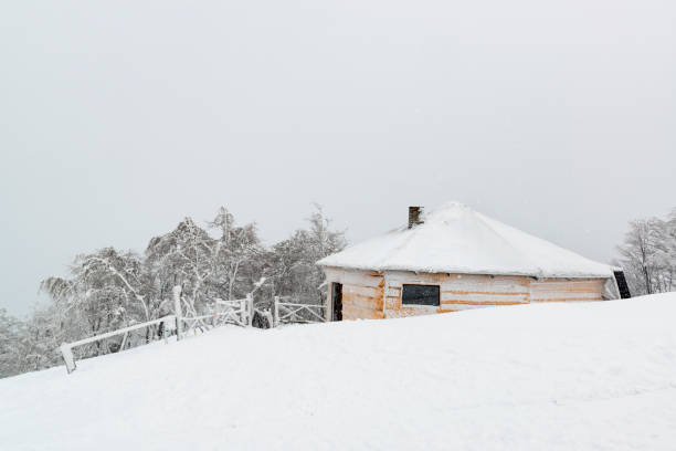 istock Beautiful winter scene with cabin covered by deep snow 1129296375