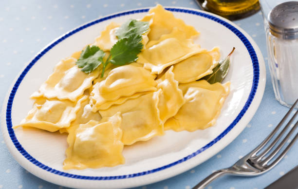 istock Delicious appetizing ravioli with bay leaf and black pepper 1129311095