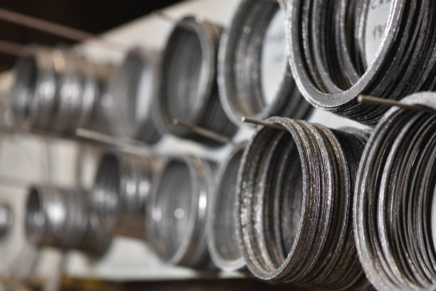 Special ring gasket for connecting two metal parts hang on the stand at the manufacturer of valves for water or gas. Special ring gasket for connecting two metal parts hang on the stand at the manufacturer of valves for water or gas. Selective focus gasket stock pictures, royalty-free photos & images