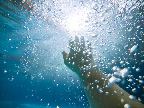 istock first person view. drowning man under water. air bubbles 1129314096