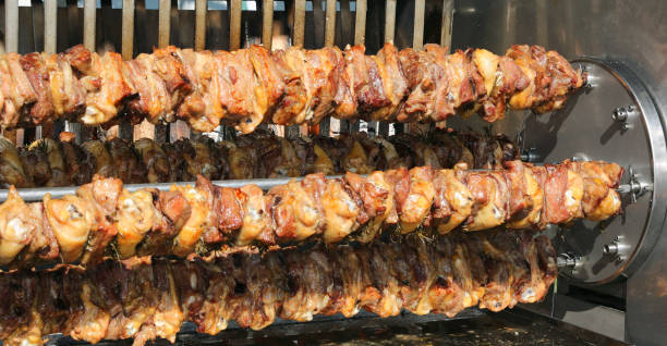 istock spit with chicken and pork meat cooked in the roaster during the 1129314744