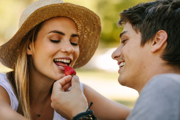 istock Romantic couple on picnic sitting in park 1129317271