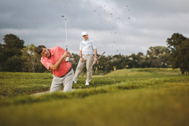 istock Golfer hitting the ball out of a sand bunker 1129317623