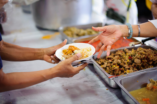 Volunteers serving food for poor people : Food sharing concept