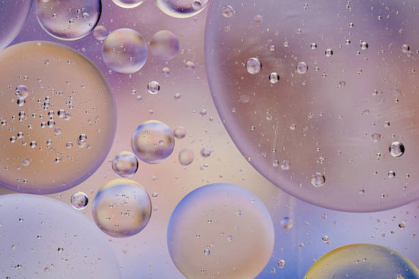 istock Water oil bubble macro abstract background flow liquid blue white pink colors 1129320709