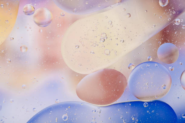 istock Water oil bubble macro abstract background flow liquid blue white pink colors 1129320711