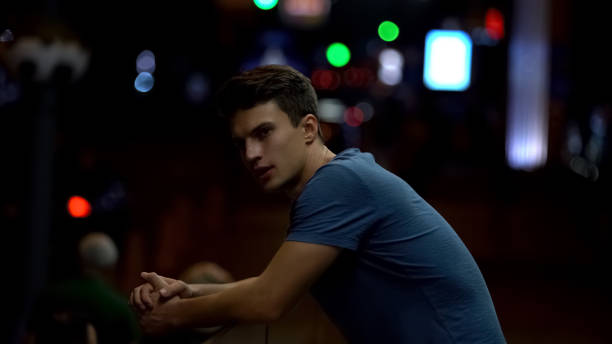 istock Lonely sad young man standing alone, quarrel in relationship and break up 1129321725