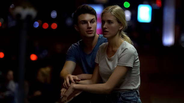 istock Young couple arguing and breaking down relationship, night street background 1129321727