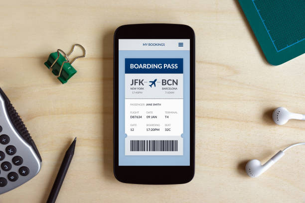 istock Boarding pass concept on smart phone screen on wooden desk 1129326970