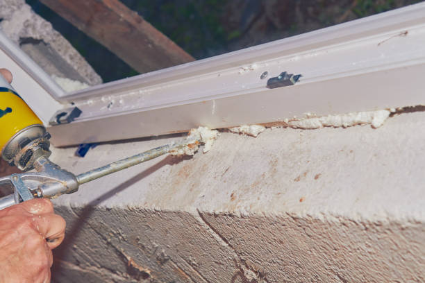 istock Construction worker puts expandable foam on the PVC window for insulation. 1129327188