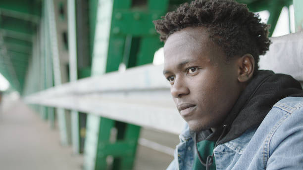 istock Portrait of young African man posing under bridge. 1129327394