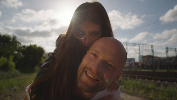 istock Young woman on man's back. Rock and roll style. 1129327745