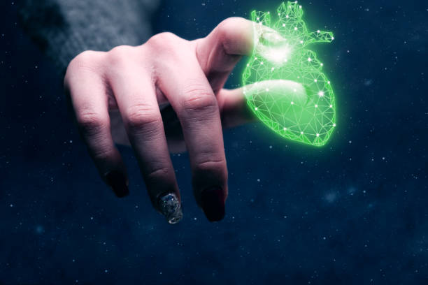 istock Human forefinger touches neon green heart innovative technologies. Mixed media. 1129327761