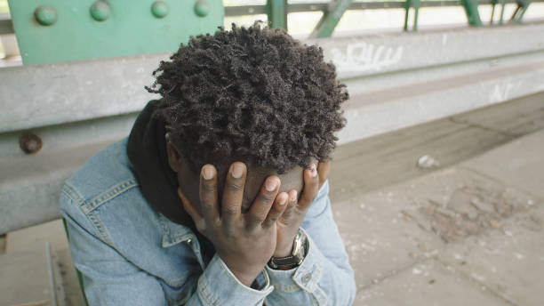 istock Lone and despaired young man sitting under bridge 1129327968