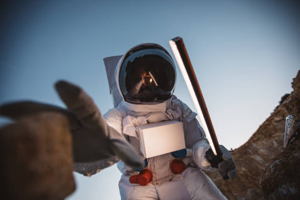 istock Cosmonaut picking up a rock from Mars 1129328023