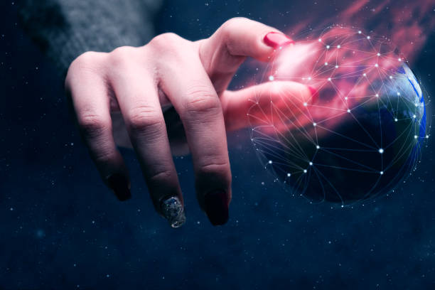 istock Woman touching planet with finger and network web and burn nebula dust. Mixed media. 1129329425