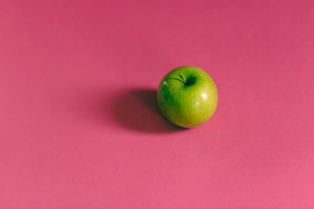 istock Fresh fruits on a pink background. 1129330115