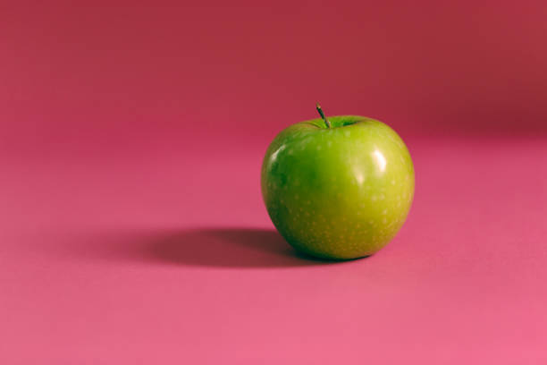 Fresh fruits on a pink background. stock photo