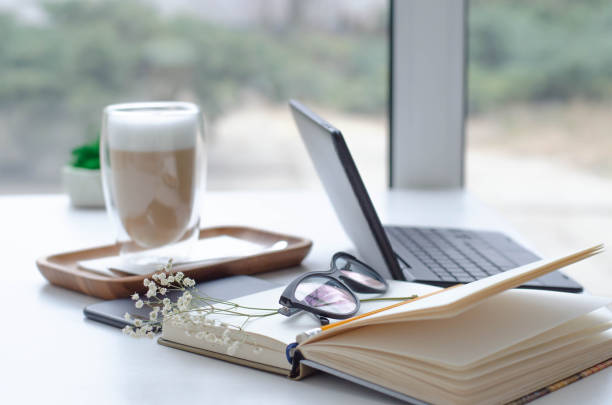 istock A table in a bright cafe with latte and freelancer work details. 1129330821