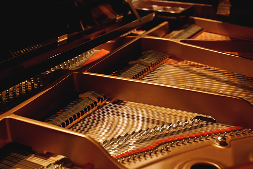 Tuning Your Piano. Close-up view of hammers, strings and pins inside the piano. Musical instruments. Piano mechanism