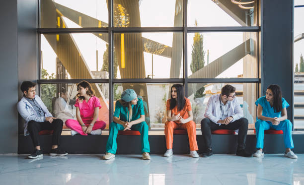 professional medical professionals waiting in line in hospital - airport waiting room waiting airport lounge imagens e fotografias de stock