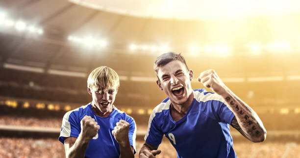 istock Happy soccer player on a football stadium 1129335601