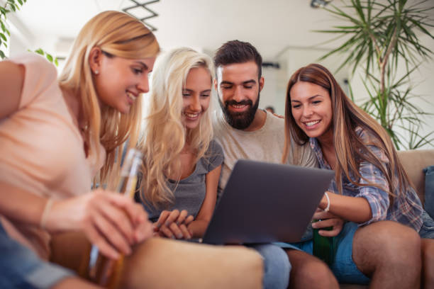 istock Friends watching football game at home 1129336055