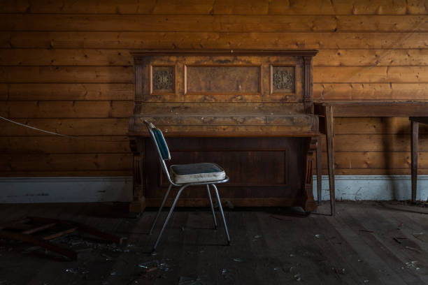 istock Abandoned Piano and Chair 1129336294