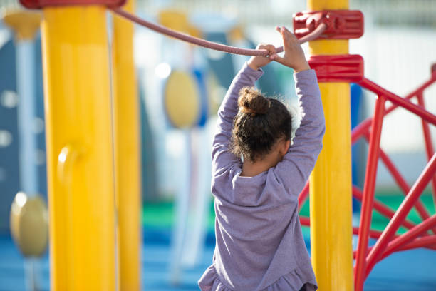 istock Girl learning to keep balance on the playground. 1129337539