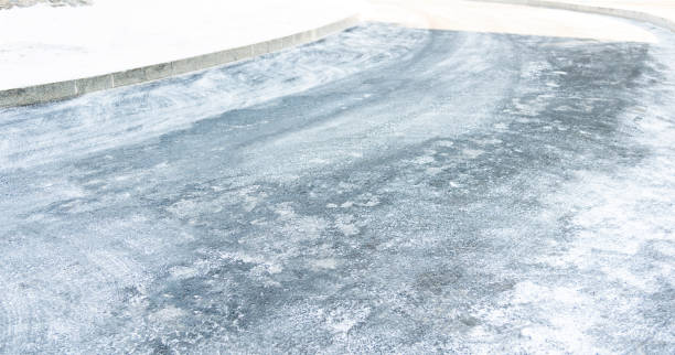 istock Tire tracks in asphalt road covering with snow 1129338869