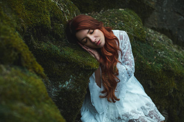 istock Dreamy girl sleeping in the forest 1129339679