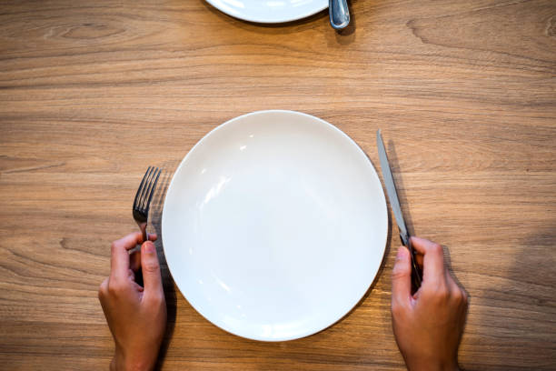 istock Person with empty plate in the restaurant 1129340754