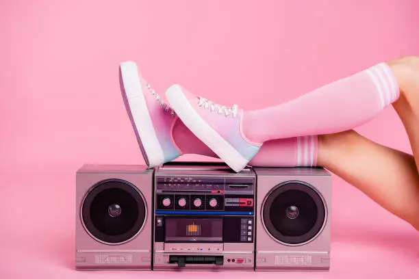 Photo of Cropped close up photo skinny perfect ideal she her lady legs lying near boom box play on fitness training workout press swing happy glad be in fit soundtrack turned on isolated pink rose background