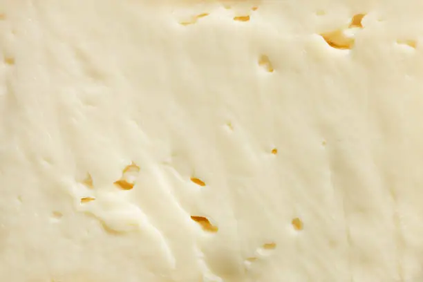 Texture of tender soft white camembert cheese, clothe-up. Copy space.