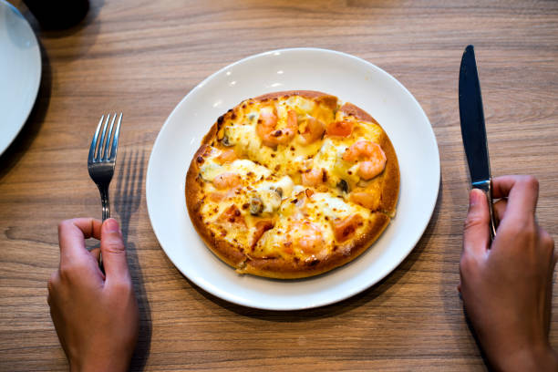 Girl eating pizza in the restaurant first person view