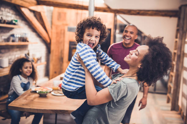 istock Playful black family having fun together in the kitchen. 1129341180