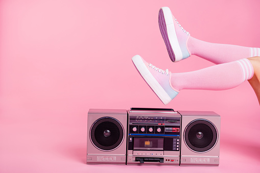 Cropped close up photo skinny perfect ideal she her lady legs raised up lying near boom box playing fitness training workout press swing happy soundtrack turned on isolated pink rose background