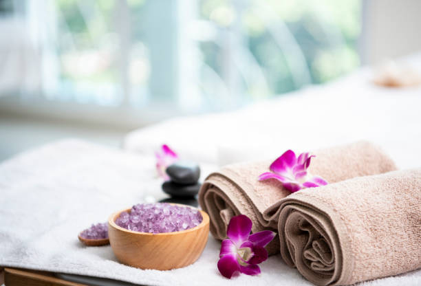 istock Spa accessories aromatic candle,orchid flower, salt scrub and towel. 1129341802