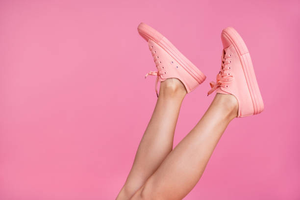 cropped close-up image view photo of nice attractive feminine fit thin slim shaven legs active sport walk go steps trendy foot-wear isolated over pink pastel background - sapato imagens e fotografias de stock